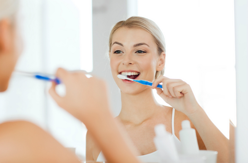 woman brushing her teeth