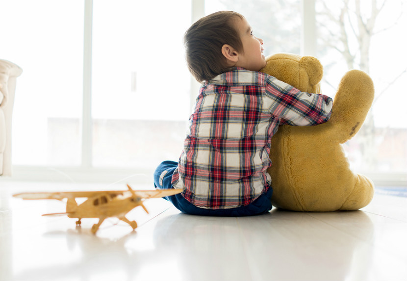 child sitting on the ground with toys