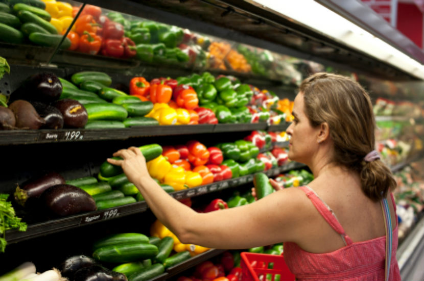 women in the produce section of the grocery store