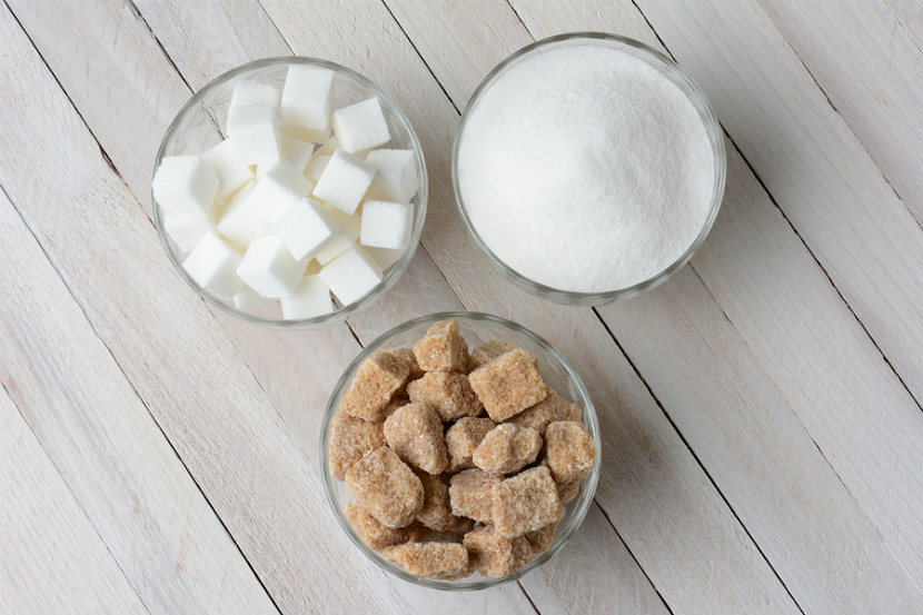 3 bowls of sugar, 1 bowl of white sugar cubes, 1 bowl of white sugar and 1 bowl of brown sugar cubes