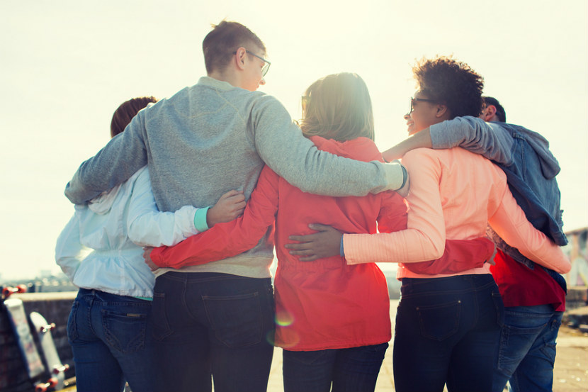 group of people with arms around each other